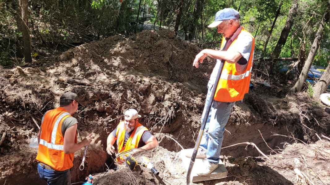 Angelina workers digging in a deep hole