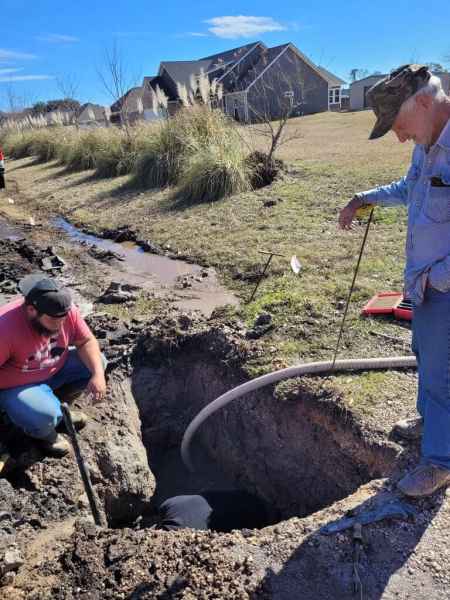 Angelina workers digging around a hole