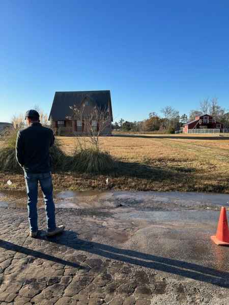 Angelina worker looking at flooding